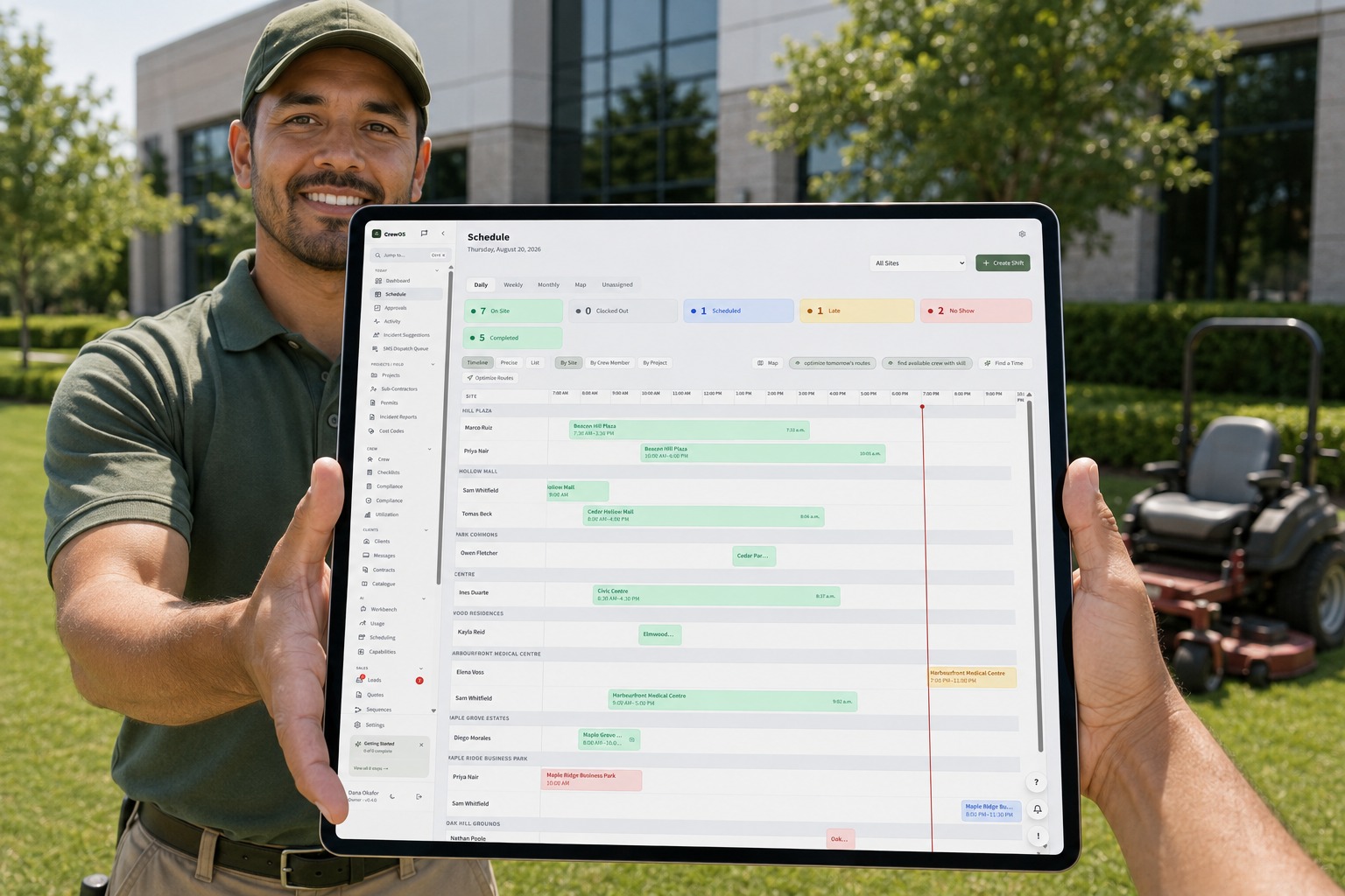 A landscaper on a maintained lawn holding a tablet that shows the CrewOS route board with live status across every property
